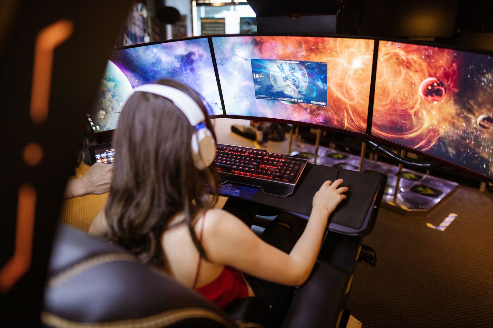 Player at a gaming PC wearing a headset during a match